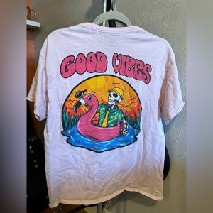"Good Vibes" t-shirt. Very light dusty pink. Skeleton beach graphic on back